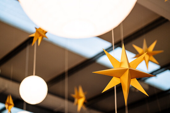 Golden paper star decorations hanging from the ceiling