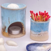 coastal wax oil burner and matchstick holder displayed with shells