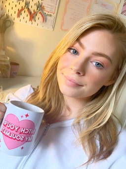 Girl with blonde hair holding a mug 