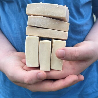 salt soaps stacked on closed hands