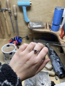 A garnet ring on a hand