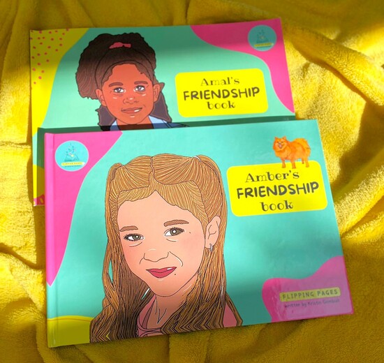 Two books are placed on a yellow blanket, they both show girls on the cover who look different (on is white and one is mixed-race - and it says Friendship Book 