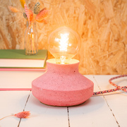 Pink jesmonite lamp with vintage bulb.