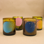 Collection of spray painted wine bottle candles inspired by the stars and planets