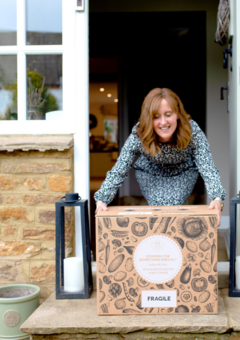 A customer receiving a delivery of 44 Foods products on her doorstep