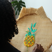 Image of Tihara Smith doing raffia hand-embroidery