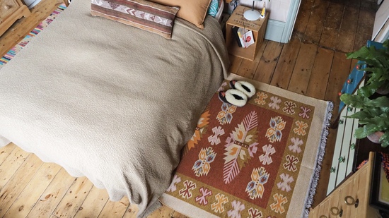 southwestern rust rug under a bed