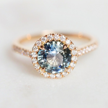 Bespoke Teal Sapphire and Rose Gold diamond halo ring.