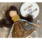 Wildflower rag doll with brown hair, mustard scarf and illustrated brown skirt and felt bag.