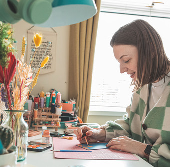 Jemma painting in her home studio.