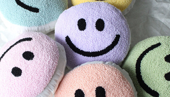 Different coloured smiley cushions