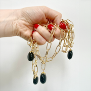 Handful of gold and onyx necklaces
