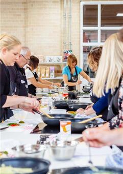 People cooking in Leeds Cookery School