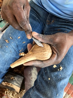Artisans carving local Mninga wood