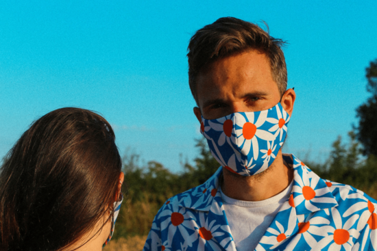 Daisy print face mask and shirt on model outdoors