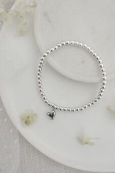 Silver plated beaded heart bracelet with cubic zirconia stone.