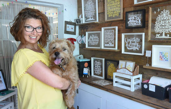 Kyleigh in her papercut shop with Archie dog