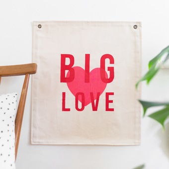 A fabric screenprinted banner with the words 'big love'