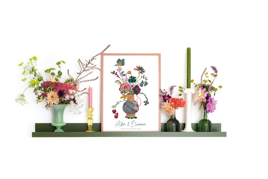 A Floradore personalised print in a frame set on a shelf alongside bouquets of fresh flowers and candles.