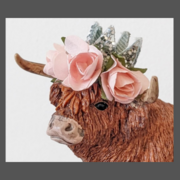 Highland cow cake topperwith silver crown and flowers on her head