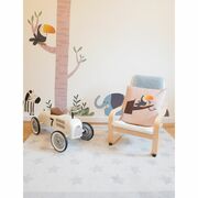 Jungle themed playroom with a vintage car and a toucan cushion placed on a wooden chair for kids