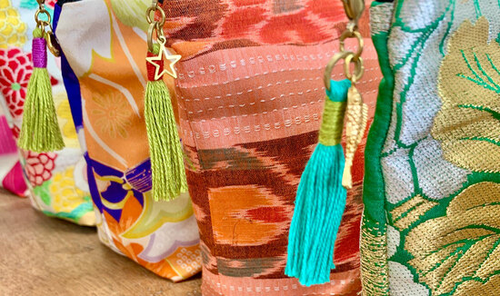 Small make up bags with tassel and brass charm detail