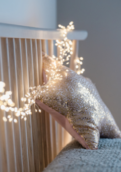 Silver Cluster Fairy Lights wrapped on the headboard