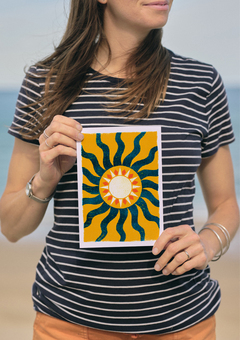 A woman holding a yellow and blue sunshine print