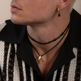 Man wearing stacked rings & layered necklaces from The 8th Jewellery