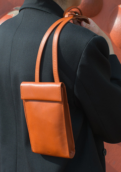 Rust Brown Phone Bag being held over the shoulder