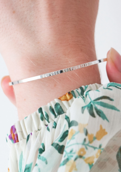 model wears slim silver bangle with words be good to yourself engraved
