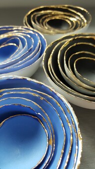 Blue and black nesting bowls with gold