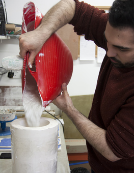 Sevak in the studio pouring into a mould