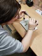 Katie preparing 6d coins for soldering