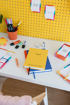 Positive Planner Products on a colourful desk