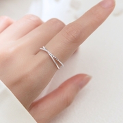 Hand wearing delicate silver ring