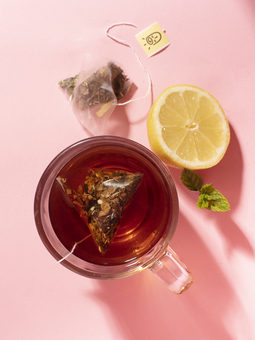 adaptogenic nootropic herbal tea blend on a pink background with lemon