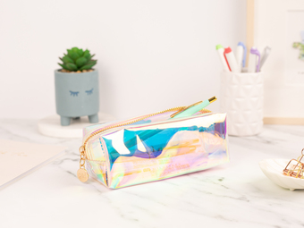Coral and Ink's clear holographic study pencil case on a study desk surrounded by Zebra Mildliner Highlighter Pens