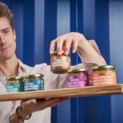 Nutcessity founder Mike displaying his products! Small-batch made, artisan nut butter.