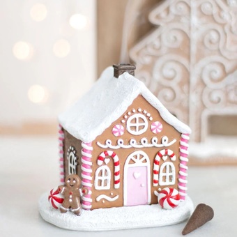 pink, red and white ceramic gingerbread house cone burner with a chimney