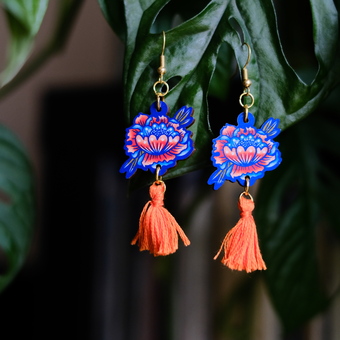 Hand drawn floral earrings with bright orange tassels