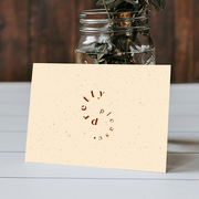 Note card with the phrase 'pretty please' leaning against a glass jar