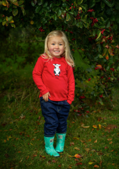 Little girl wearing red cow t-shirt by Cotswold Baby Co