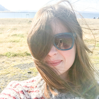 Head shot of Barnabjorn owner, Megan, with an Icelandic landscape in the background.
