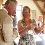 Melody Ryder meeting HRH Prince Charles and explaining the process of stitching and creating lampshades.