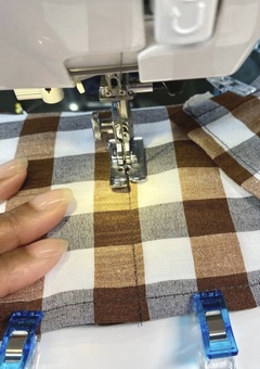 Brown gingham fabric on sewing machine.