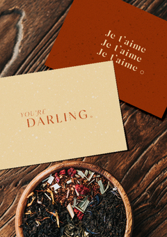 Two notecards one with the phrase 'Je t'aime' and one that says 'you're darling'