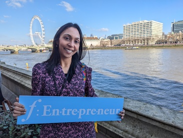 Priya Velusami holding a F:Entrepreneur sign