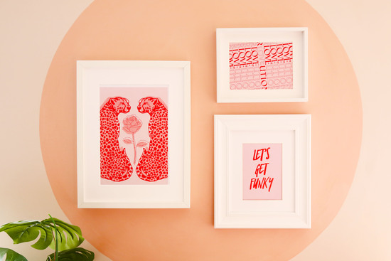 Gallery wall featuring three prints in a bold red and pink colour combination