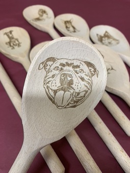A wooden spoon engraved with a Staffordshire Bull Terrier Design